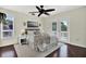 Cozy bedroom with a ceiling fan, area rug, balcony access and an ocean scene wall art at 748 Soundview Dr, Palm Harbor, FL 34683