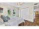 Bright bedroom with hardwood floors, ceiling fan, balcony access, and closet at 748 Soundview Dr, Palm Harbor, FL 34683
