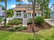 A beautifully landscaped two-story home with a manicured lawn and inviting entrance welcomes you to comfortable living at 748 Soundview Dr, Palm Harbor, FL 34683