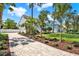 A charming two-story home with a paver driveway and lush landscaping enhances the curb appeal of this inviting property at 748 Soundview Dr, Palm Harbor, FL 34683