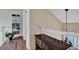 Hallway features wooden floors, shelving, and a cabinet that offers storage and character to the home at 748 Soundview Dr, Palm Harbor, FL 34683
