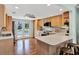 Bright kitchen featuring light wood cabinets, a tiled backsplash, modern appliances, and balcony access at 748 Soundview Dr, Palm Harbor, FL 34683