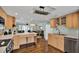 Open-concept kitchen with light wood cabinets, an island counter, stainless steel appliances, and hardwood floors at 748 Soundview Dr, Palm Harbor, FL 34683