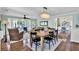 Spacious living and dining area with a fireplace, chandelier, hardwood floors, and plenty of natural light at 748 Soundview Dr, Palm Harbor, FL 34683