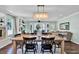 Open-concept living and dining area featuring a fireplace, hardwood floors, stylish decor, and natural light at 748 Soundview Dr, Palm Harbor, FL 34683
