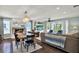 Open-concept living and dining area featuring a fireplace, hardwood floors, and stylish decor at 748 Soundview Dr, Palm Harbor, FL 34683