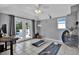 Bright living room with a treadmill, yoga mat, and access to the pool through glass doors at 748 Soundview Dr, Palm Harbor, FL 34683