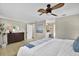 Elegant main bedroom featuring a decorative painting, a ceiling fan, and well-placed lighting creating a cozy sanctuary at 748 Soundview Dr, Palm Harbor, FL 34683