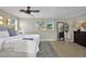Well-lit main bedroom with stylish decor, including a ceiling fan and a decorative tree that exudes elegance at 748 Soundview Dr, Palm Harbor, FL 34683