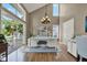 Bright office space with vaulted ceiling, hardwood floors, a modern chandelier, and balcony access at 748 Soundview Dr, Palm Harbor, FL 34683