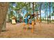 Fun playground with various play structures, set in a natural environment with lush trees and landscaping at 748 Soundview Dr, Palm Harbor, FL 34683