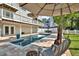 Backyard pool area with an umbrella and seating area at 748 Soundview Dr, Palm Harbor, FL 34683