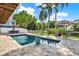 A beautiful backyard oasis with a sparkling pool and lush tropical landscaping offers private relaxation and entertaining at 748 Soundview Dr, Palm Harbor, FL 34683