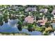 Aerial view of a luxurious home on a picturesque lake and beautiful landscaping at 8016 Bounty Ln, Bradenton, FL 34202