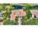 Gorgeous home with a red tile roof, lush greenery, and a brick driveway at 8016 Bounty Ln, Bradenton, FL 34202