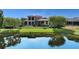 Beautiful backyard featuring a pond view, mature trees, and a wrought iron fence at 8016 Bounty Ln, Bradenton, FL 34202