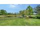Backyard view of the lake and landscaping at 8016 Bounty Ln, Bradenton, FL 34202