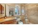 Charming bathroom with granite counters, a glass shower, and a serene view from the arched window at 8016 Bounty Ln, Bradenton, FL 34202