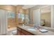 Bathroom with granite countertops, travertine tile, and shower/tub combo with a calming aesthetic at 8016 Bounty Ln, Bradenton, FL 34202