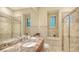 Elegant bathroom features a marble countertop, glass shower, and tiled walls, creating a spa-like experience at 8016 Bounty Ln, Bradenton, FL 34202