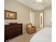 Comfortable bedroom with an accent chair, ample natural light, and neutral-toned decor at 8016 Bounty Ln, Bradenton, FL 34202