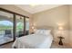 Serene bedroom with a private balcony, features a comfortable bed, neutral decor, and ample natural light at 8016 Bounty Ln, Bradenton, FL 34202