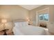 Cozy bedroom with a comfortable bed, neutral-toned walls, and ample natural light from the nearby window at 8016 Bounty Ln, Bradenton, FL 34202