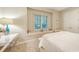 Bright bedroom showcasing a window seat, white walls, and comfortable bed with beautiful neutral-toned accents at 8016 Bounty Ln, Bradenton, FL 34202