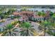 Stunning clubhouse with lush landscaping, porte cochere and elegant architecture, overlooking lake at 8016 Bounty Ln, Bradenton, FL 34202