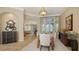 Spacious dining room with tile flooring, modern lighting, and views into the living area at 8016 Bounty Ln, Bradenton, FL 34202
