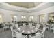 Elegant dining room featuring round tables, high ceilings, neutral colors, and ample natural light at 8016 Bounty Ln, Bradenton, FL 34202