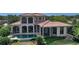 An exterior elevation of the home showcasing the tile roof and outdoor pool at 8016 Bounty Ln, Bradenton, FL 34202