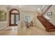 Open foyer with tile flooring, staircase, and a view of the front entrance at 8016 Bounty Ln, Bradenton, FL 34202