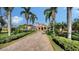 Elegant two-story home featuring a red tile roof, arched entrance, and lush tropical landscaping at 8016 Bounty Ln, Bradenton, FL 34202