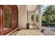 Charming front porch with double doors, tile flooring, and elegant columns at 8016 Bounty Ln, Bradenton, FL 34202