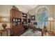 Inviting home office with custom built-ins, ample storage, and a large arched window at 8016 Bounty Ln, Bradenton, FL 34202