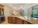 Open kitchen with granite countertops, custom cabinetry, and view of living area at 8016 Bounty Ln, Bradenton, FL 34202