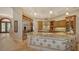 Spacious kitchen with stainless steel appliances, custom cabinets, and large kitchen island at 8016 Bounty Ln, Bradenton, FL 34202