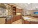 Chef's kitchen featuring an island, cooktop, custom cabinetry and backsplash at 8016 Bounty Ln, Bradenton, FL 34202