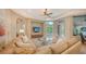 Spacious living room with coffered ceilings, plush seating, and a view of the pool area at 8016 Bounty Ln, Bradenton, FL 34202