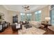 Elegant living room featuring hardwood floors, large windows, and stylish decor at 8016 Bounty Ln, Bradenton, FL 34202