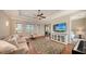 Spacious living room boasts hardwood floors, large windows, a ceiling fan, and access to an outdoor space at 8016 Bounty Ln, Bradenton, FL 34202