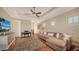 Elegant living room featuring a comfortable sofa, hardwood floors, a large window, and a sophisticated area rug at 8016 Bounty Ln, Bradenton, FL 34202