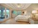 Spacious main bedroom featuring tray ceiling, fan, and private access to the outdoor living area at 8016 Bounty Ln, Bradenton, FL 34202