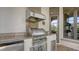 Outdoor kitchen boasts stainless steel appliances, stone countertops, and built-in storage, perfect for entertaining at 8016 Bounty Ln, Bradenton, FL 34202