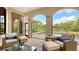Covered outdoor living area showcasing elegant seating, a view of the pool, and lush landscaping at 8016 Bounty Ln, Bradenton, FL 34202