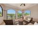 Relaxing patio with serene views, featuring comfortable seating and tiled flooring, perfect for enjoying the outdoors at 8016 Bounty Ln, Bradenton, FL 34202
