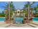 Beautiful pool with fountain feature and tropical landscaping, set against the backdrop of an elegant building at 8016 Bounty Ln, Bradenton, FL 34202