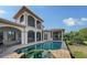 A gorgeous outdoor pool and deck highlight this elegant home's backyard living space at 8016 Bounty Ln, Bradenton, FL 34202