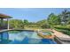 A beautiful swimming pool and spa with a stunning view of the golf course and pond at 8016 Bounty Ln, Bradenton, FL 34202